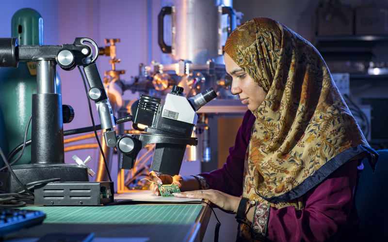 Farah Fahim at a microscope